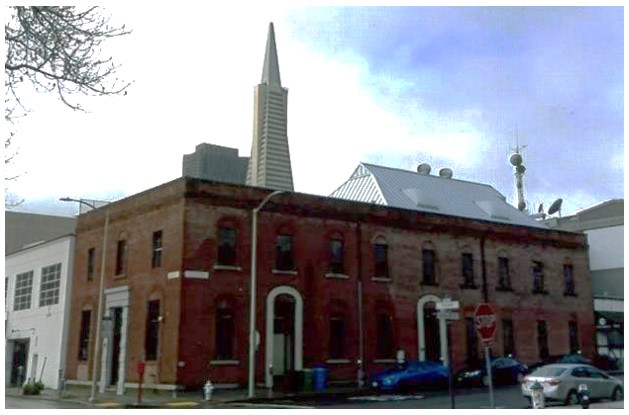 Corner view of the brick former dockside warehouse currently reused as office space.